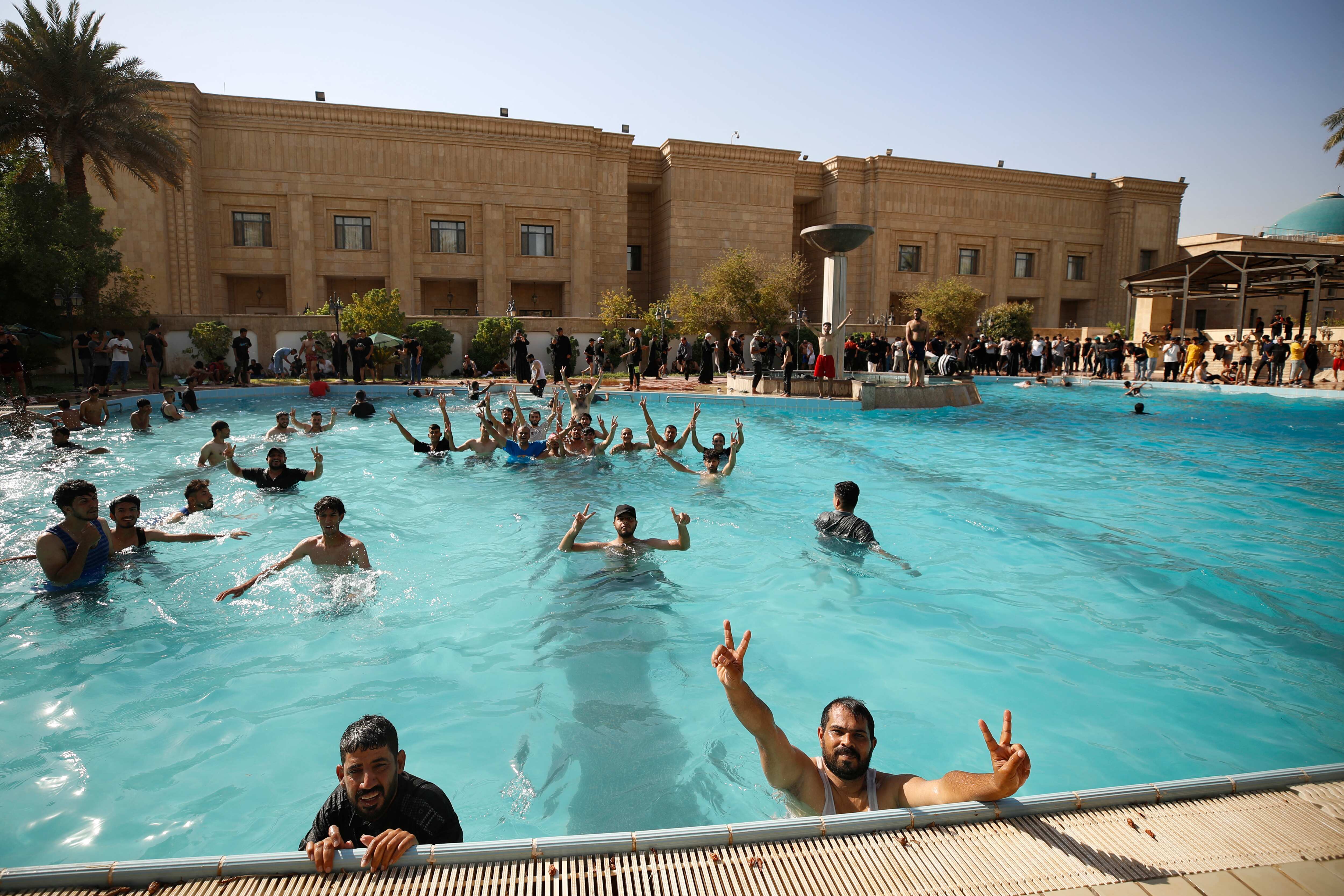 Iraqi Protesters Take Dip In Pool After Storming Presidential Palace In