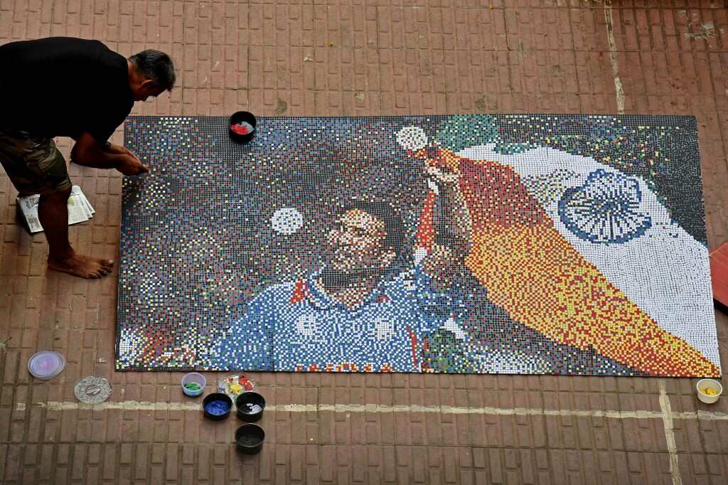 Artist Abhishek Nandkishor creates a paper mosaic of former Indian cricket player Sachin Tendulkar on the eve of his birthday in Mumbai on April 23, 2021.