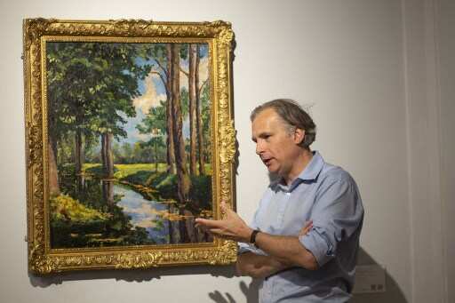 Jean Paul Engelen, Deputy Chairman and worldwide co-head of 20th century and contemporary art at Phillips Auction House speaks next to "The Moat, Breccles" painting made by Winston Churchill and owned by the Onassis family, in New York.