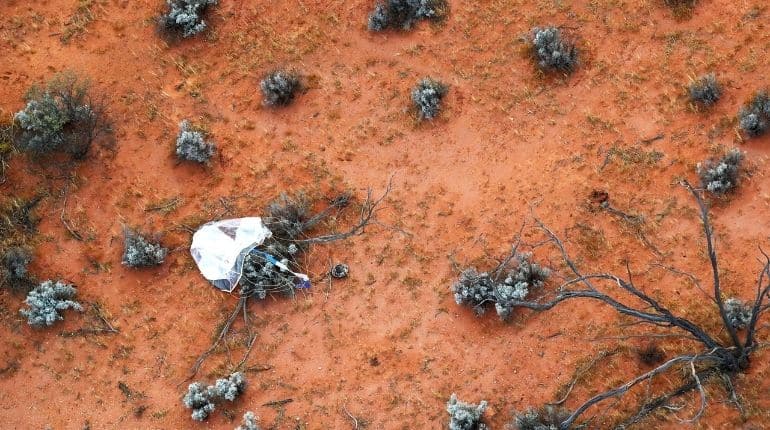 In this handout image from Japan Aerospace Exploration Agency (JAXA), Hayabusa2's capsule carrying the first extensive samples of an asteroid is seen after it landed in the Woomera restricted area, Australia, December 6, 2020