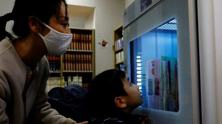 A ultraviolet sterilising machine cleaning library books, amid the coronavirus disease (COVID-19) outbreak, at Narimasu library in Itabashi district in Tokyo, Japan, December 9, 2020