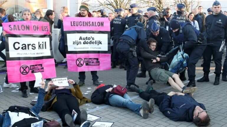 Demonstrators lie in a street during a protest of the climate action group Extinction Rebellion at Brussels Motor Show in Brussels