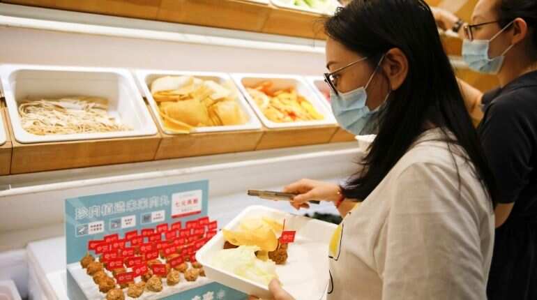 Customers choose the ingredients for their meal at a Hope Tree restaurant which is offering plant-based meatballs produced by Zhenmeat in Beijing, China September 4, 2020. Picture taken September 4, 2020