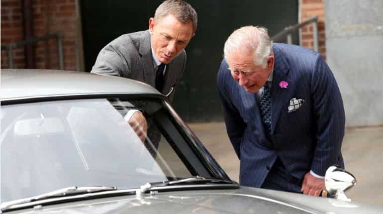 Daniel Craig shows Prince Charles the Aston Martin