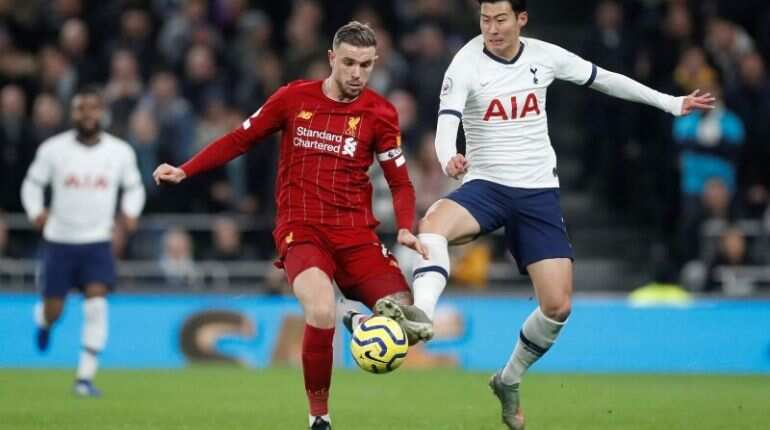 Liverpool's Jordan Henderson in action with Tottenham Hotspur's Son Heung-min