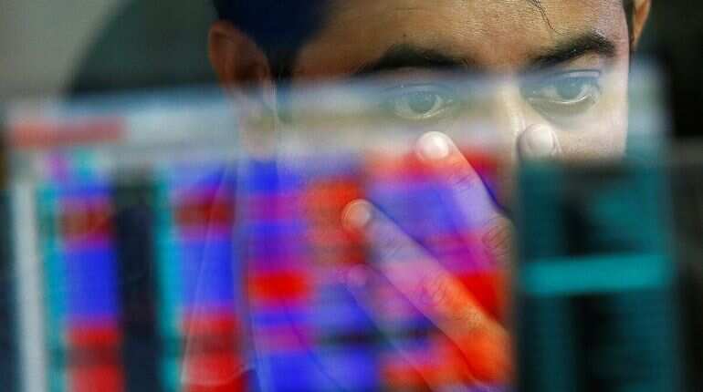 A broker reacts while trading at his computer terminal