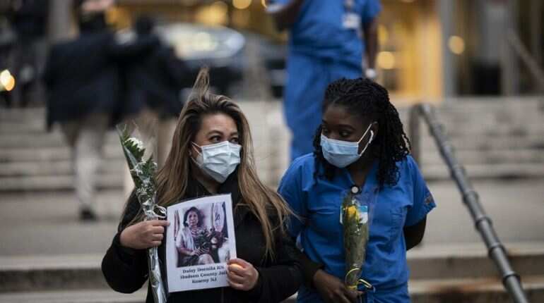 Nurses and healthcare workers light candles as they mourn and remember their colleagues who died during the outbreak of the novel coronavirus (which causes COVID-19) during a demonstration outside Mount Sinai Hospital in Manhattan on April 10, 2020 in New York City