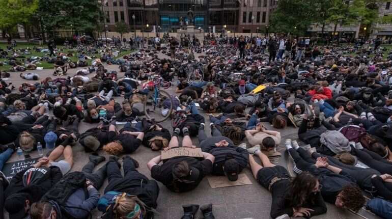 Protesters hold a die-in as they gather peacefully to protest the death of George Floyd at the State Capital building in downtown Columbus, Ohio, on June 1,2020.