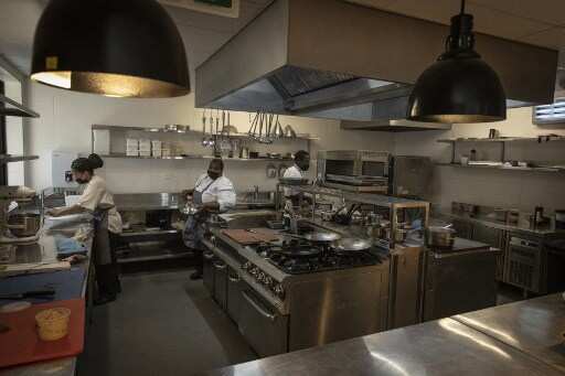 Nelson Mandela's personal chef Xoliswa Ndoyiya prepares a dish at the hotel restaurant in his former home