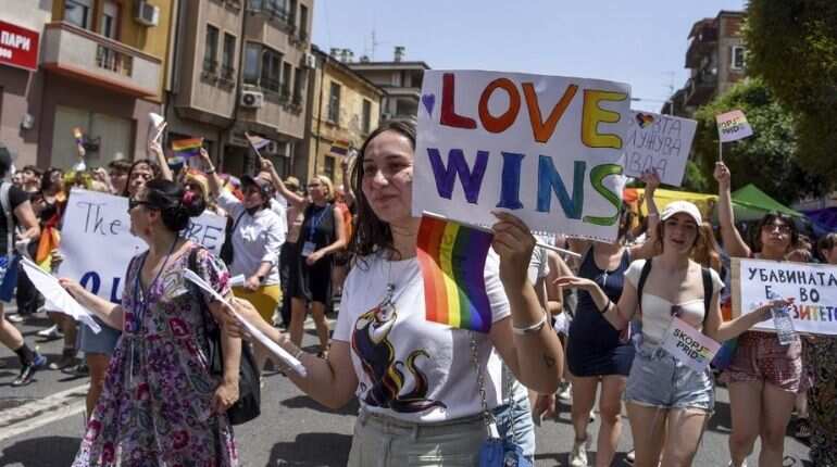 Participants hold signs as they take part in the "Skopje Pride", the second Pride march in downtown Skopje on June 26, 2021.