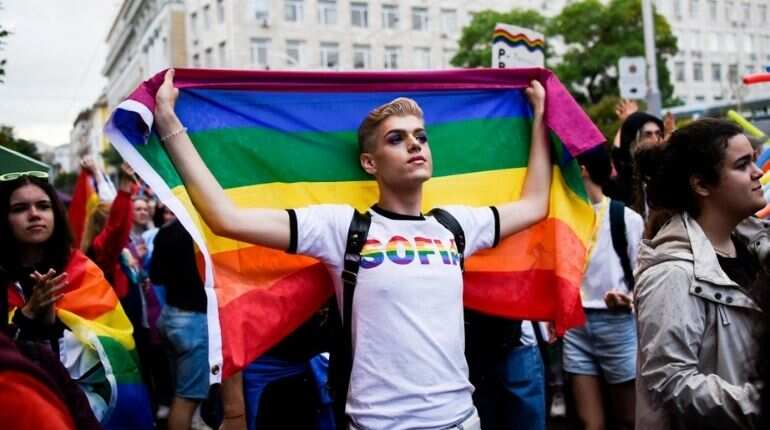An activist holds a rainbow flag during the annual Gay Pride Parade in downtown Sofia, on June 12, 2021.
