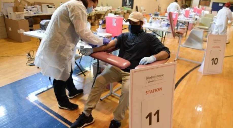 Several US states report spike in coronavirus cases as stocks plunge