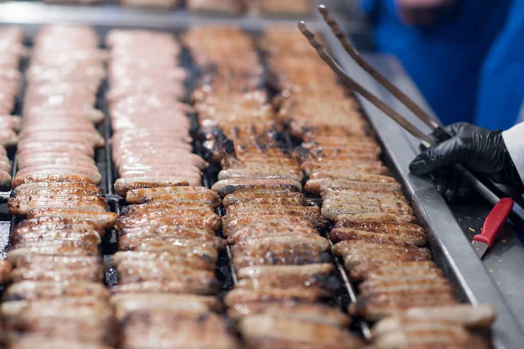 Traditional Nuernberger Rostbratwuerste sausages lie on a grill prior to the opening of the 2016 Nuremberg Christmas Market in Nuremberg, Germany