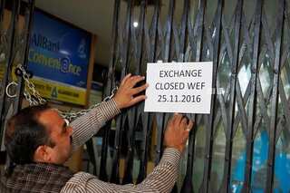 Exclusive: Touts, bank managers beat the system to convert black money into white