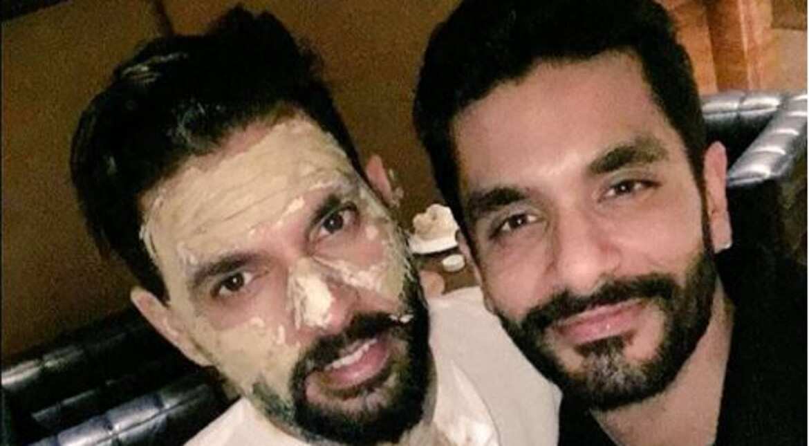 Yuvraj poses for a photograph with a friend after the "haldi" ceremony, a pre-wedding ritual that involves applying turmeric on the groom's face.