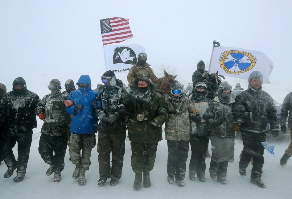 Military veterans march in support of the 'water protectors' at Oceti Sakowin Camp on the edge of the Standing