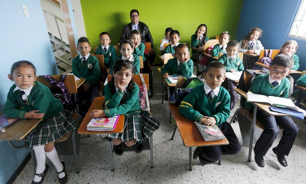 Bogot?, ColombiaFr Juan Humberto Cruz with fourth-grade students at Semillas de Esperanza (Seeds of Hope) school in SoachaPhotograph: John Vizcaino