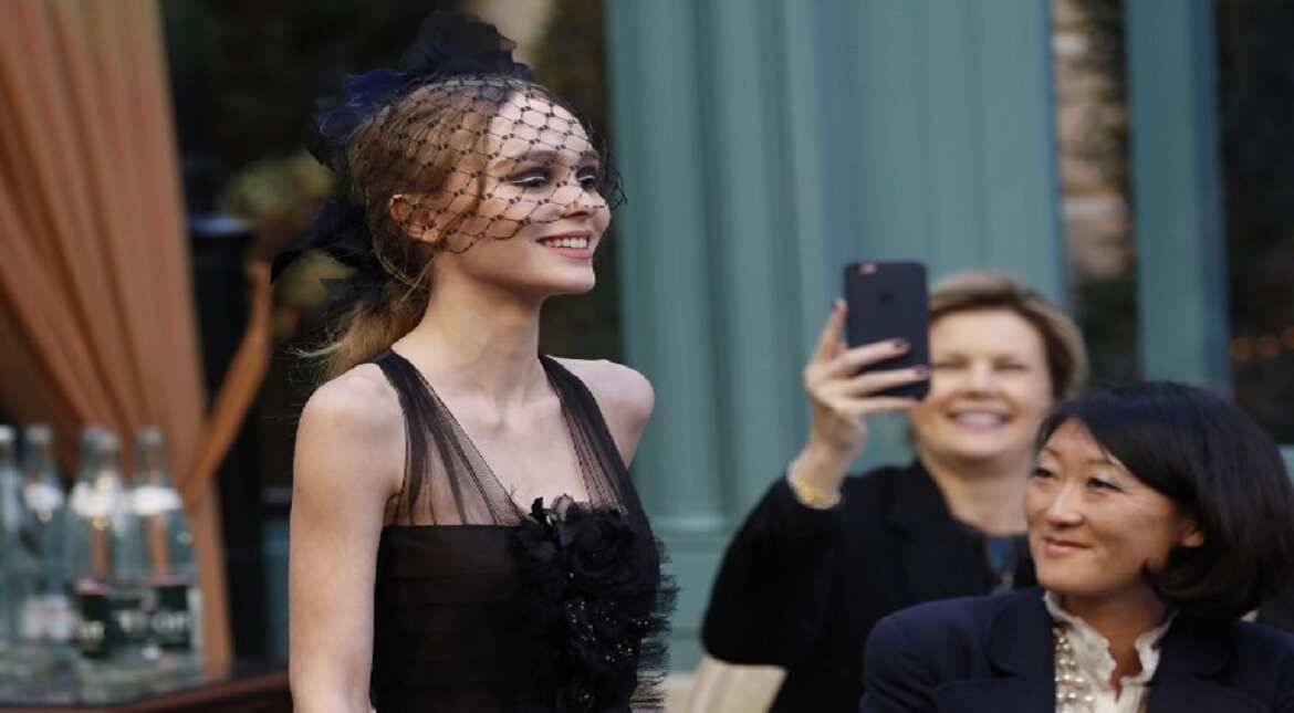 French-American actress and model Lily-Rose Depp presents a creation for Chanel, near former French Culture Minister Fleur Pellerin, during the 13th