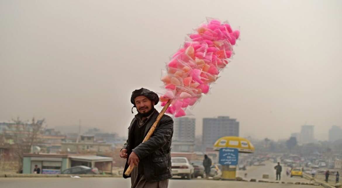 An Afghan vendor sells candy floss as he walks on the streets of Kabul.