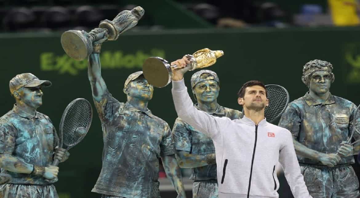 Serbia's Novak Djokovic poses with the winner's trophy after beating Britain's Andy Murray