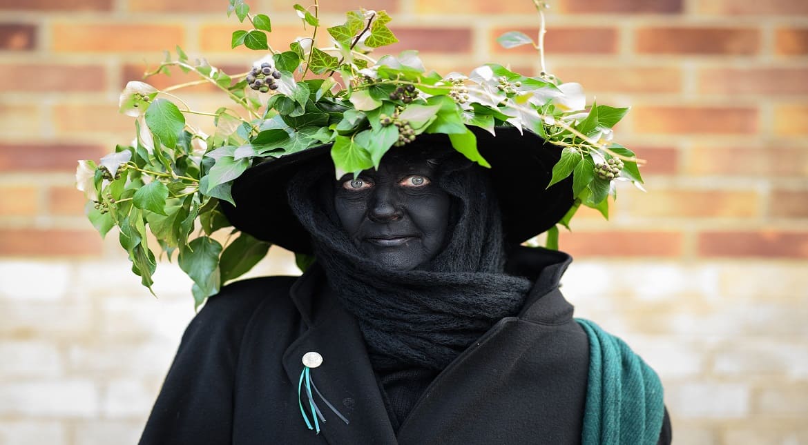 A woman wearing a crown of ivy poses for a photograph before the annual Whittlesea Straw Bear Festival parade in Whittlesey, United Kingdom.