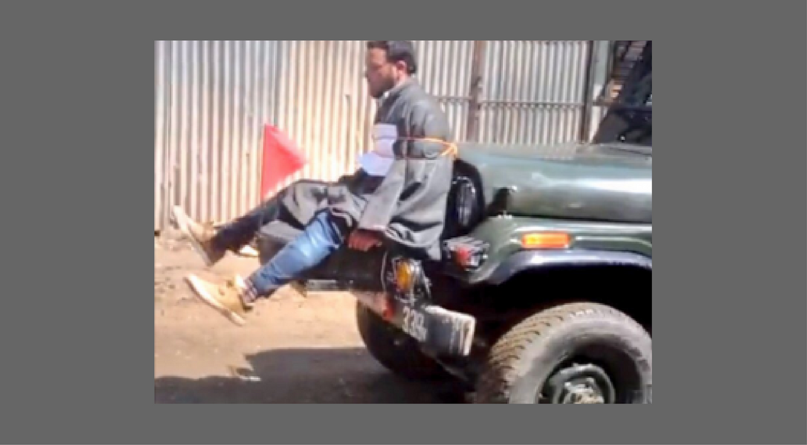 A man was  strapped to the front of a police jeep purportedly to be used as a human shield against stone pelters