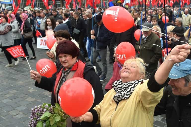 People hold red balloons during a May Day rally organised by the Ukrainian left-wing parties and the trade unions in Kiev on May 1, 2017.