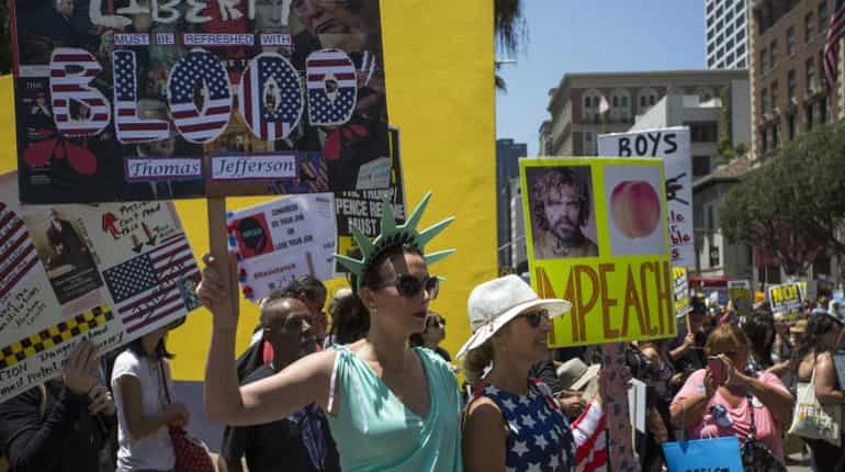 People participate in the Impeachment March on July 2 in LA, California