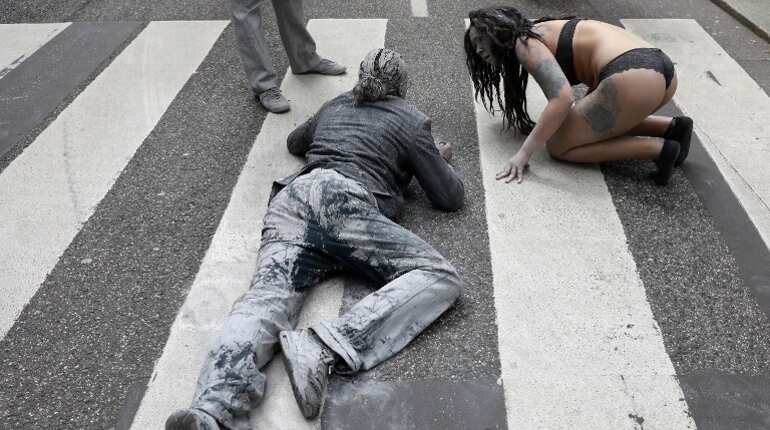 Activists covered themselves in grey clay