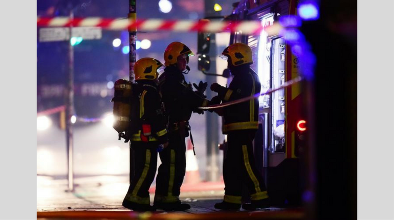 Firefighters standing near the Camden Market fire