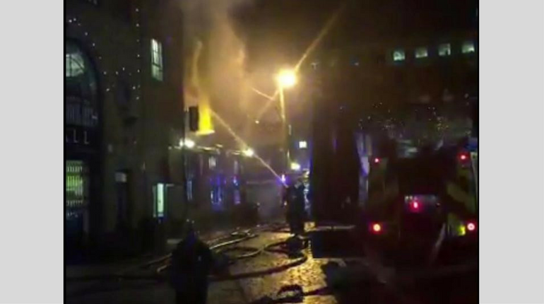 Firefighters spraying water at the Camden fire