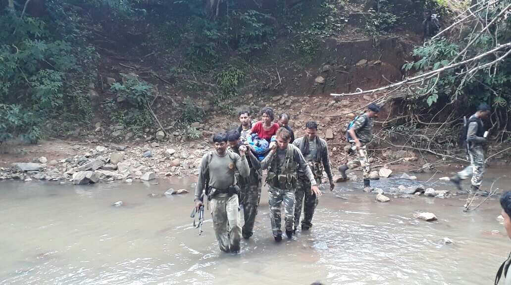 CRPF Troops carried a woman in stretcher on shoulders, evacuated her to health center CRPF Troops carried a woman in stretcher on shoulders, evacuated her to health center
