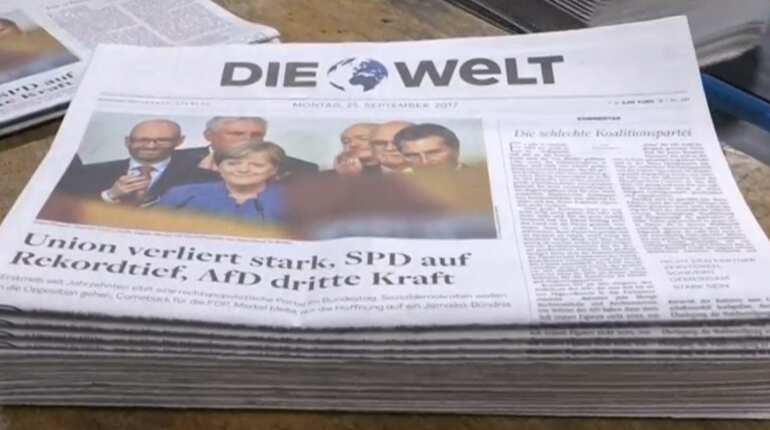 Weakened Angela Merkel wins fourth term, hit by nationalist 'earthquake'