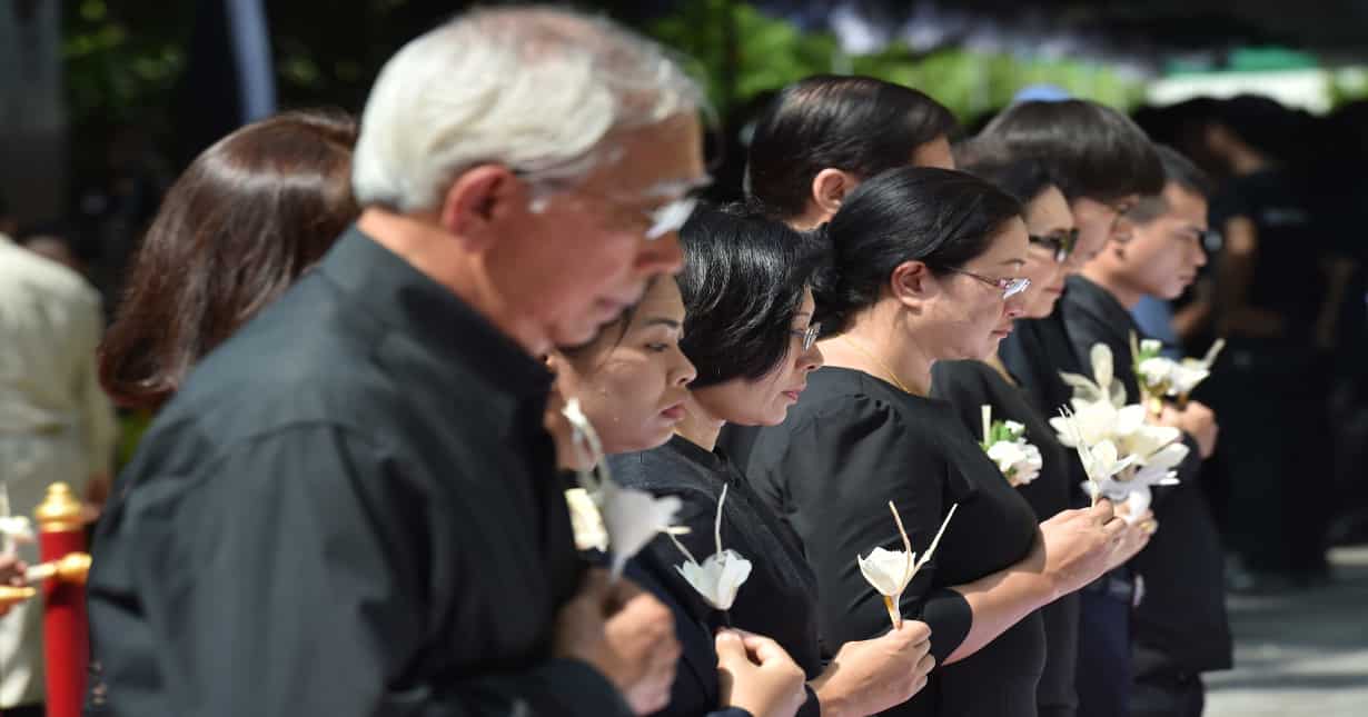 Mourners lay flowers as a sign of respect for the late Thai king