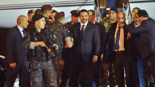 Hariri, back in Beirut, attends national day parade