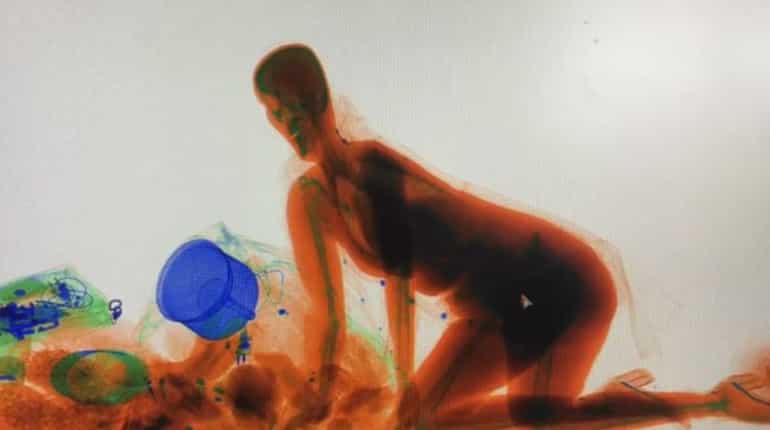 Watch: To protect handbag, Chinese woman climbs into X-ray scanner