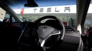 Why did a taxi firm in Paris suspend use of Tesla Model 3 cars?