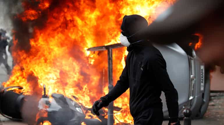 Riot police, masked protesters clash at Paris May Day rally