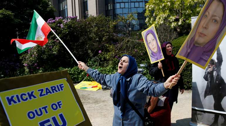 A protester chants slogans against the visit of Iran's Foreign Minister