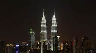 Malaysia tightens curbs in capital as virus cases climb