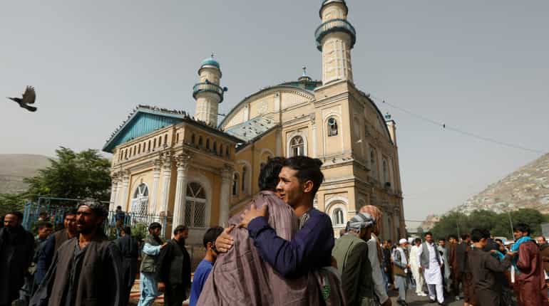 Afghan soldiers and Taliban militants celebrate together