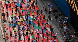 Thousands of yoga practitioners hit Times Square to welcome summer