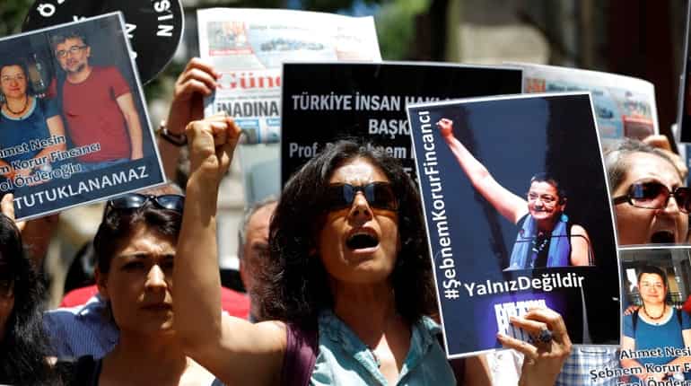 Turkish demonstrators protest arrest of 2 journalists and 1 academic for 'terrorist propaganda'