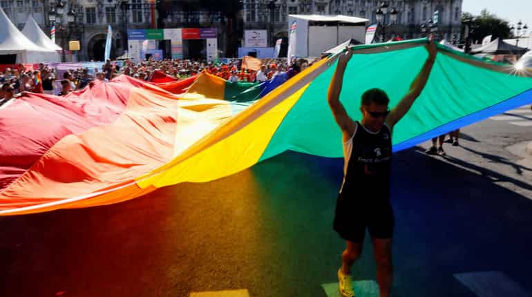 People display a huge rainbow flag