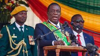 Zimbabwe president says currency under attack as prices spiral