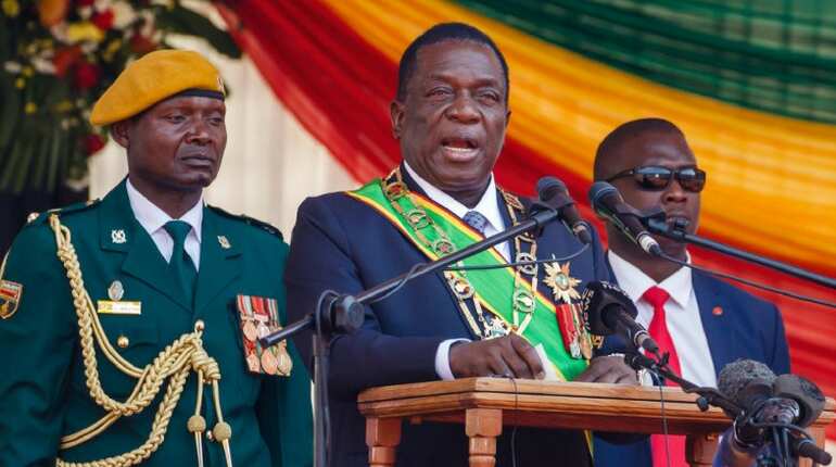 Zimbabwe president says currency under attack as prices spiral