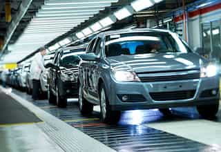 Auto executives going soft on acquisitions, says E&Y.