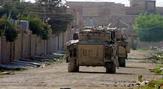 US-backed Syrian rebel commander says clash on with IS fighters in border town