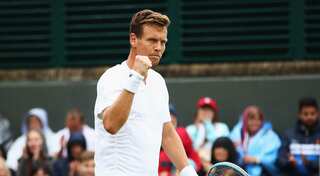 Berdych battles to four-set win at rain-hit Wimbledon