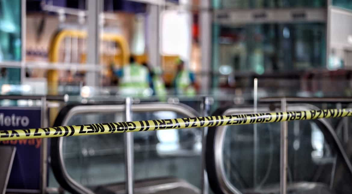 A blast site is cordoned off at Ataturk airport. A tourist caught up in the onslaught said one of the attackers was dressed all in black and that he was 'randomly shooting' into the departures hall.